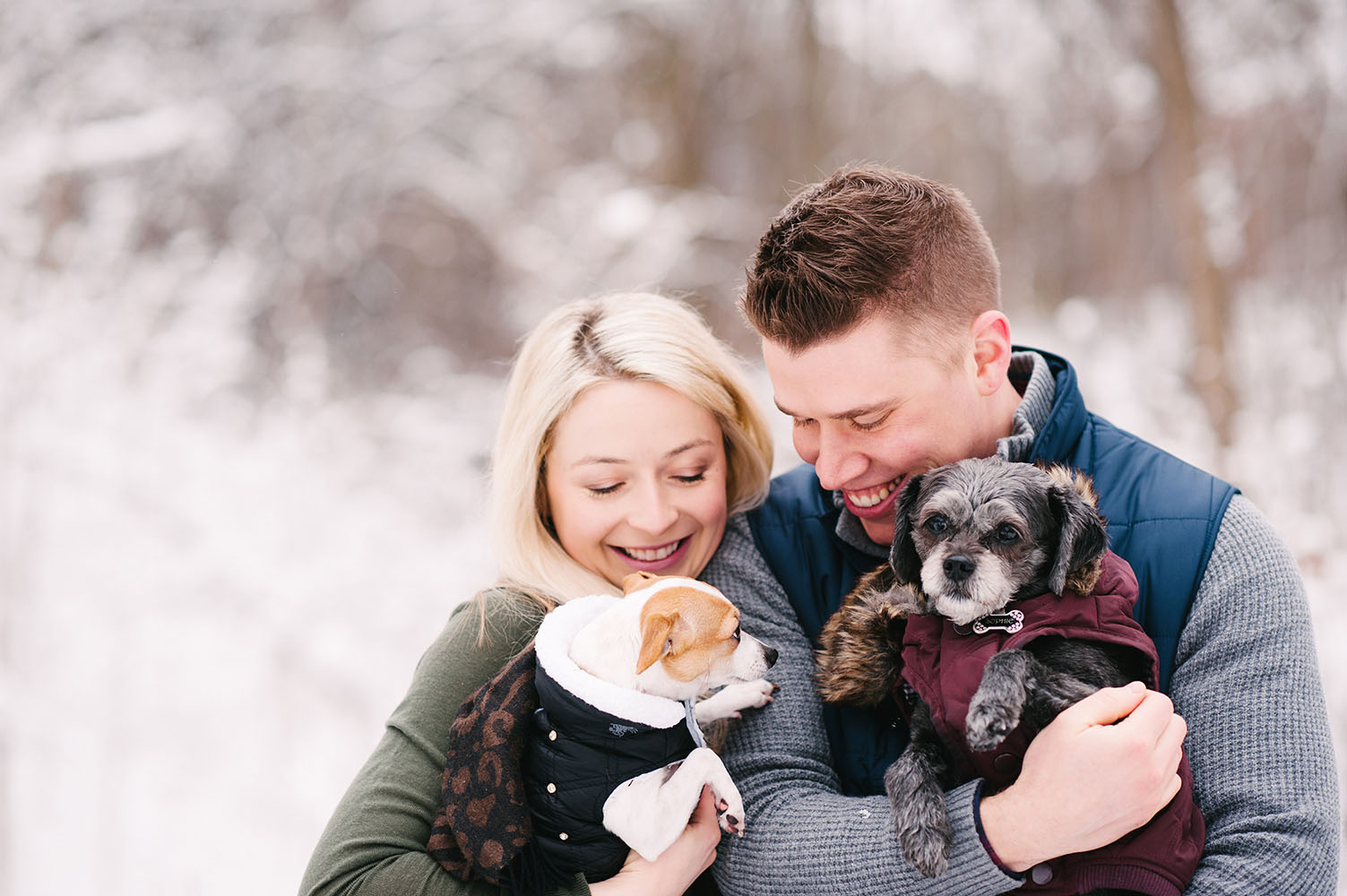 young couple with dogs in snow
