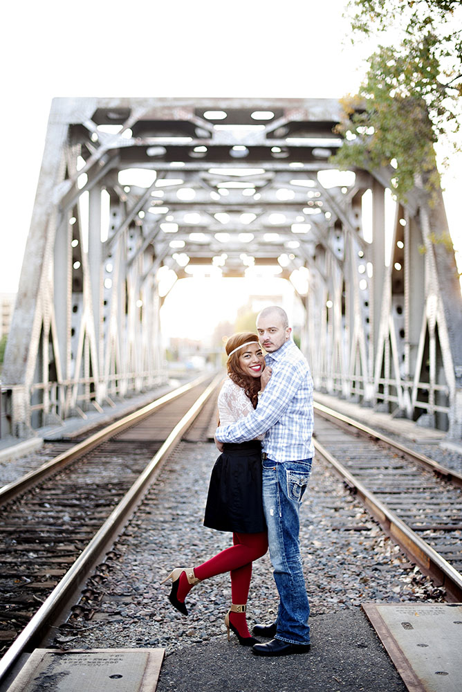 couple embracing on railroad tracks