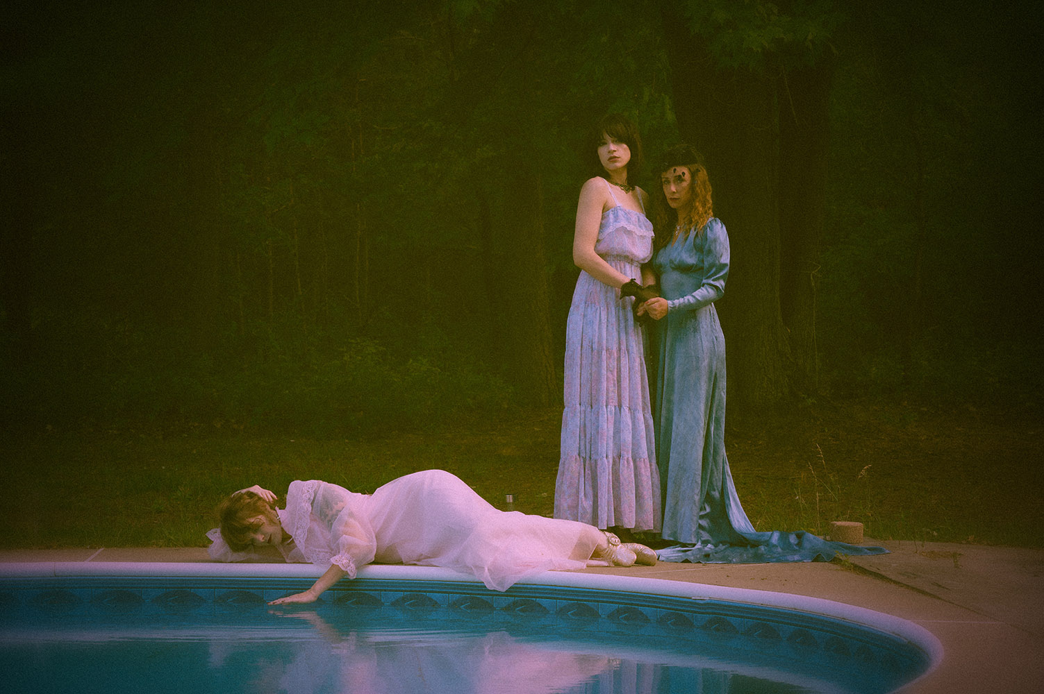 three women by a pool