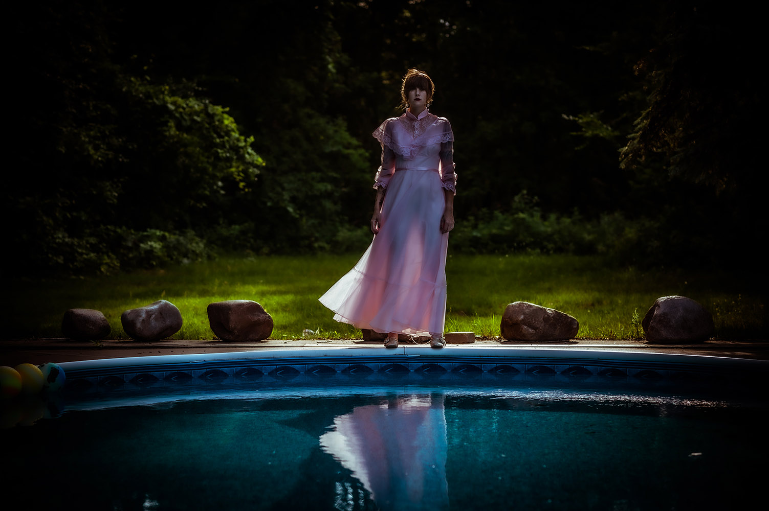 woman in a dress by a pool