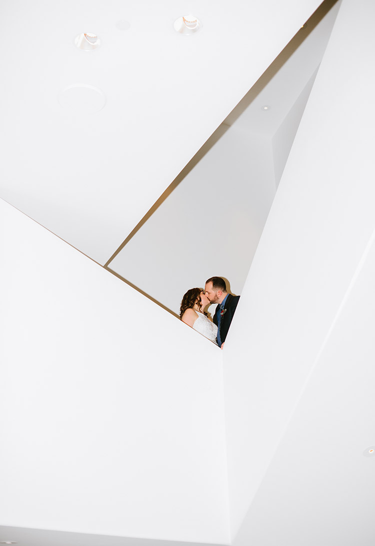 Bride and Groom kissing in architectural space at The Walker Art Center