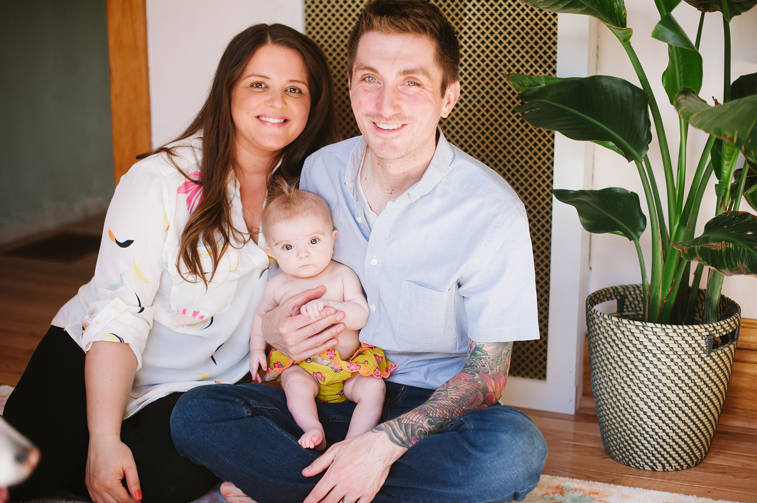 a couple and baby in their home