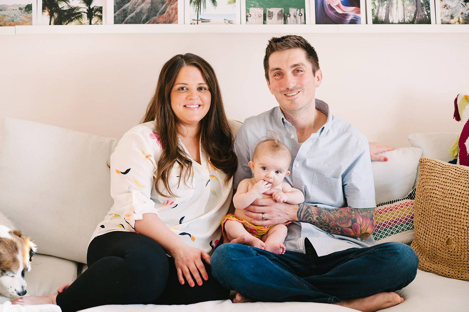 a couple and their baby on the couch