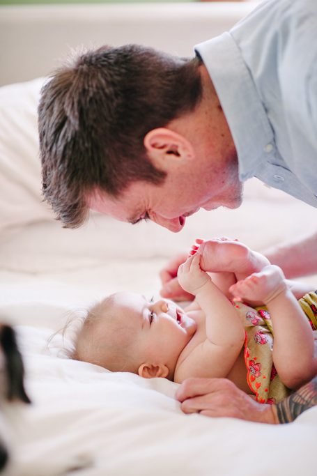 a man snuggling with a baby