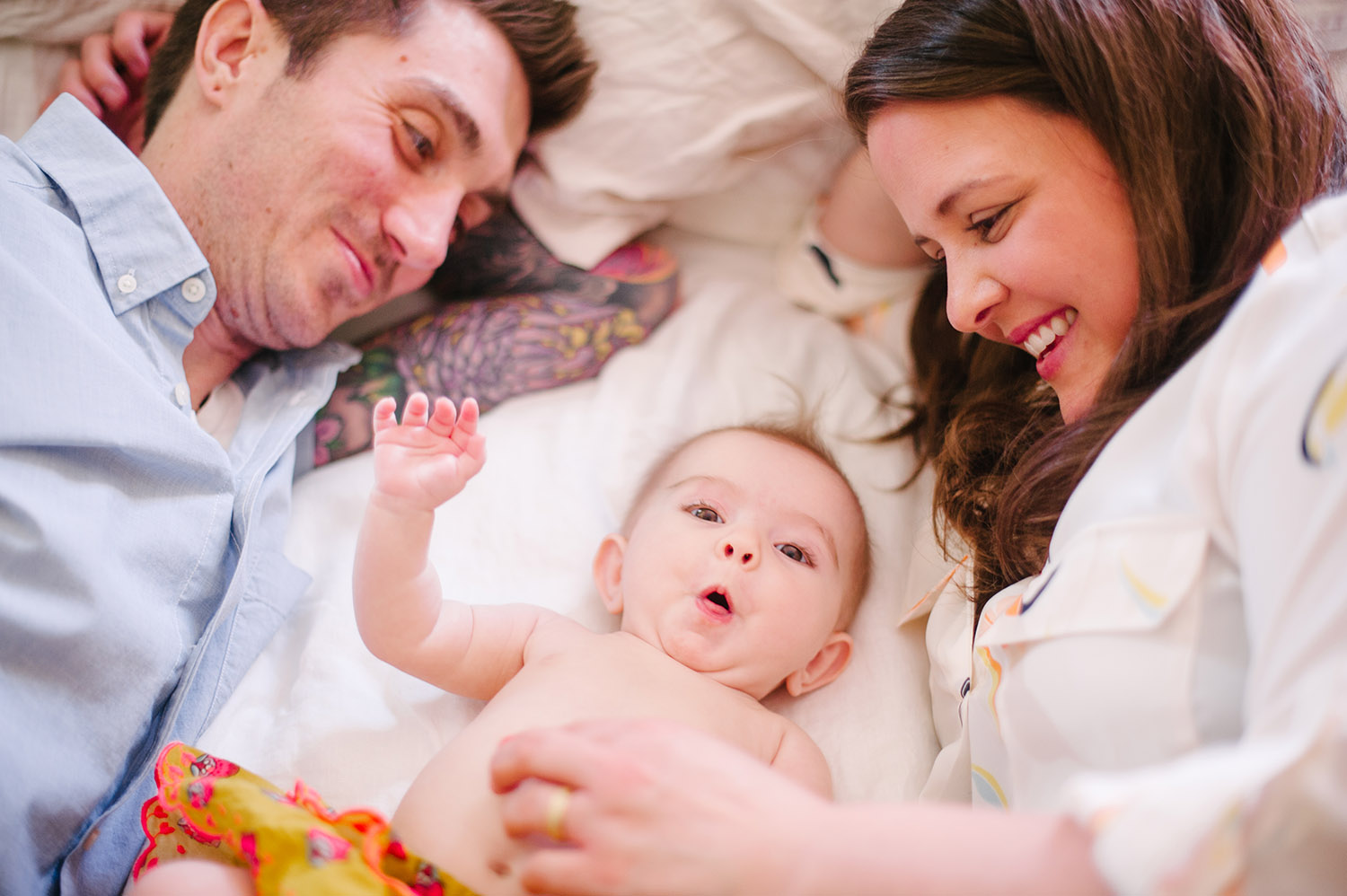 a couple cuddling with their baby