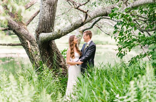 Bride and Groom in grass with tree