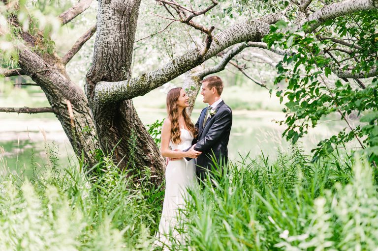 Bride and Groom in grass with tree