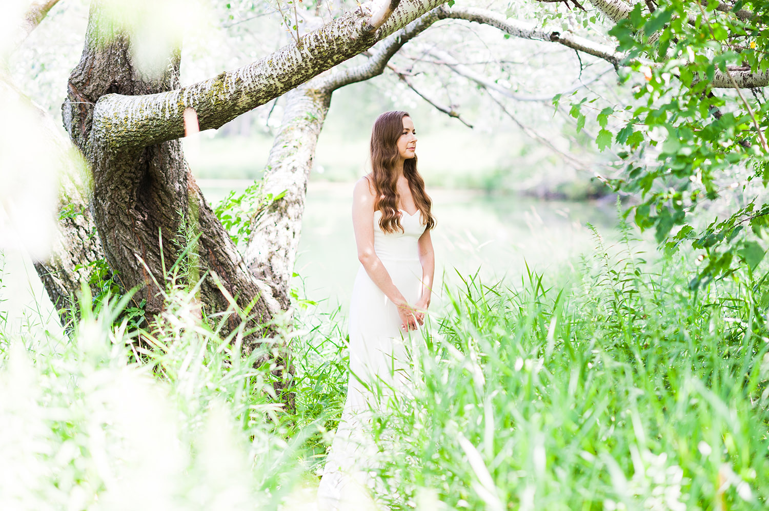 bride with long, dark wavy hair in nature