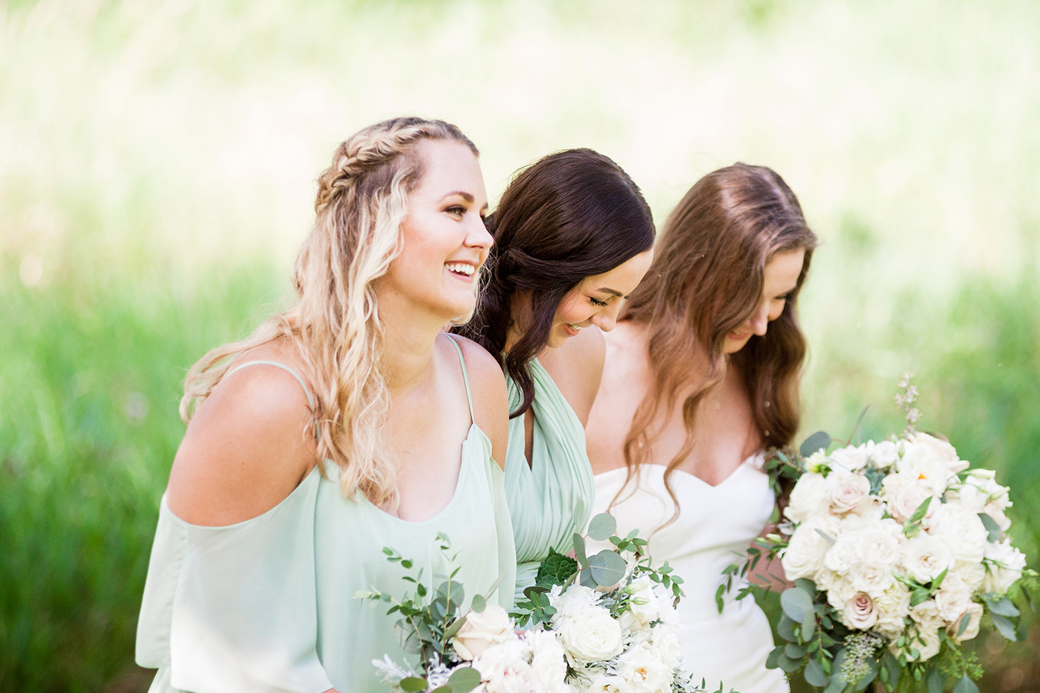 bride with bridesmaids in pale green dresses