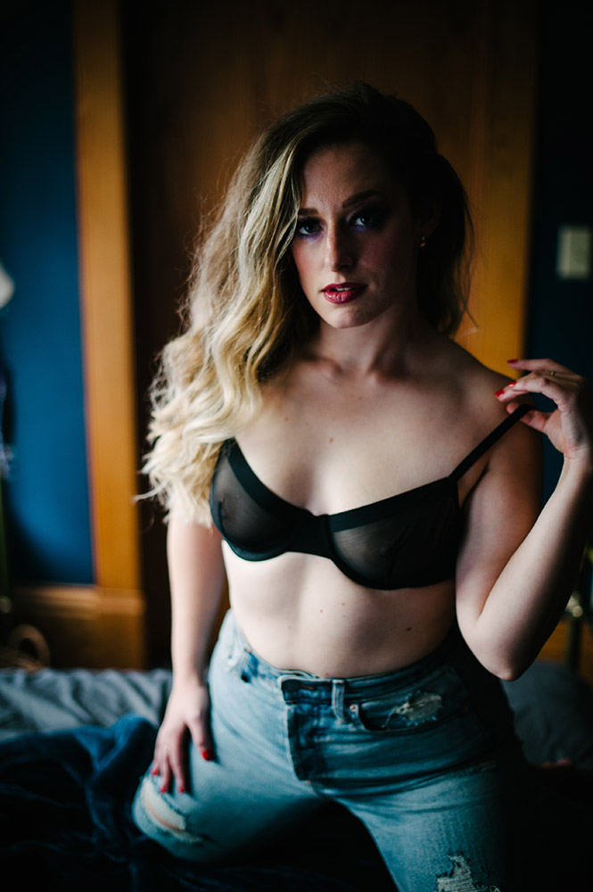 blond woman in boudoir black bra