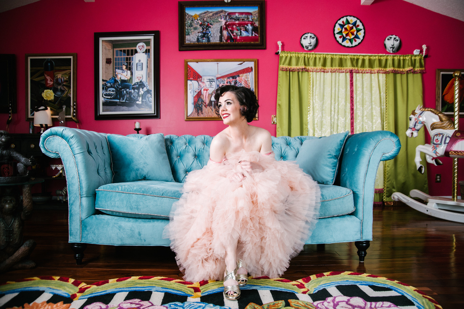 a white woman in a pink frilly robe on a blue couch at the Zebra House