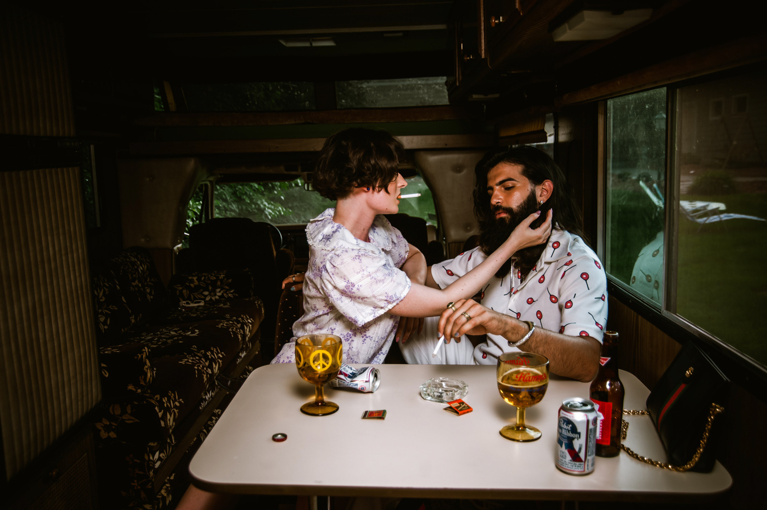 a man and a woman inside an RV hanging out