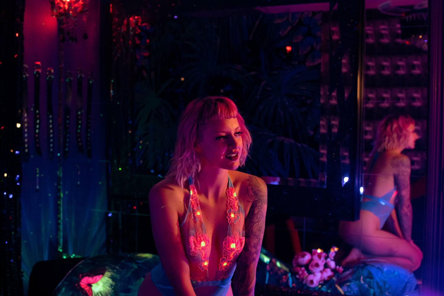 black light boudoir photo of woman in floral lingerie